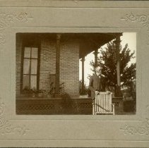 Unidentified Man Standing in Front of a Porch